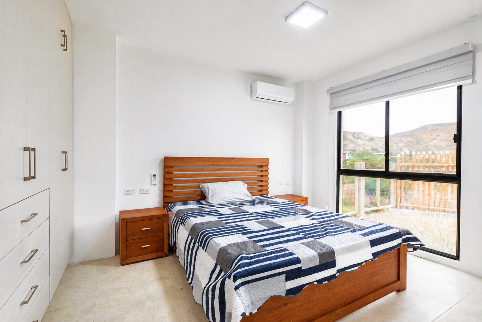 Bright guest bedroom with built-in storage and hillside views in Santa Marianita
