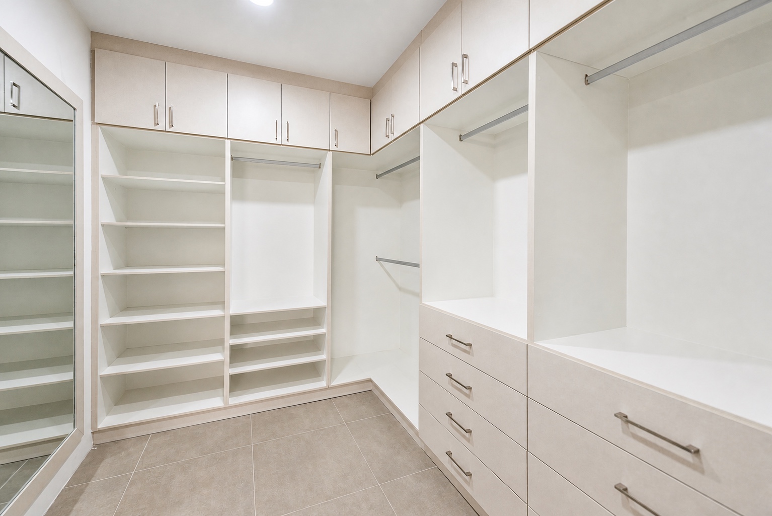 Spacious walk-in closet with shelving, drawers, and hanging storage