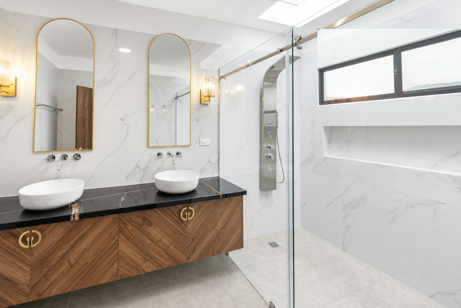 Luxury bathroom with a double vanity, gold-framed mirrors, and glass shower