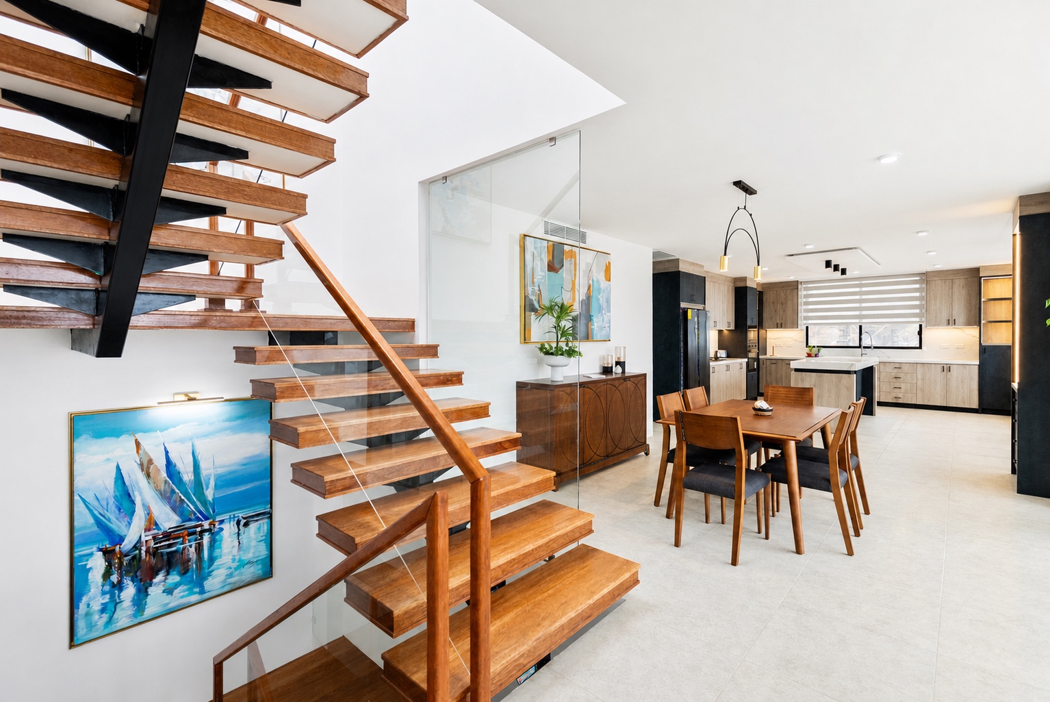 Open staircase beside the dining room and modern kitchen at the Santa Marianita oceanfront villa