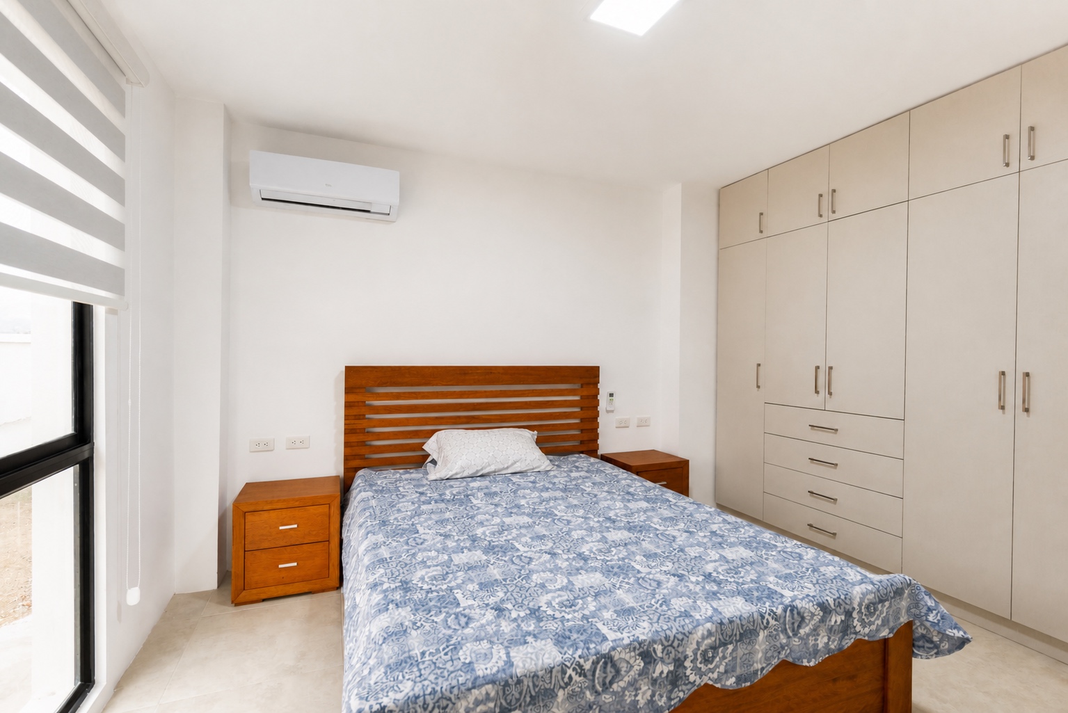 Comfortable guest bedroom with built-in wardrobes and air conditioning