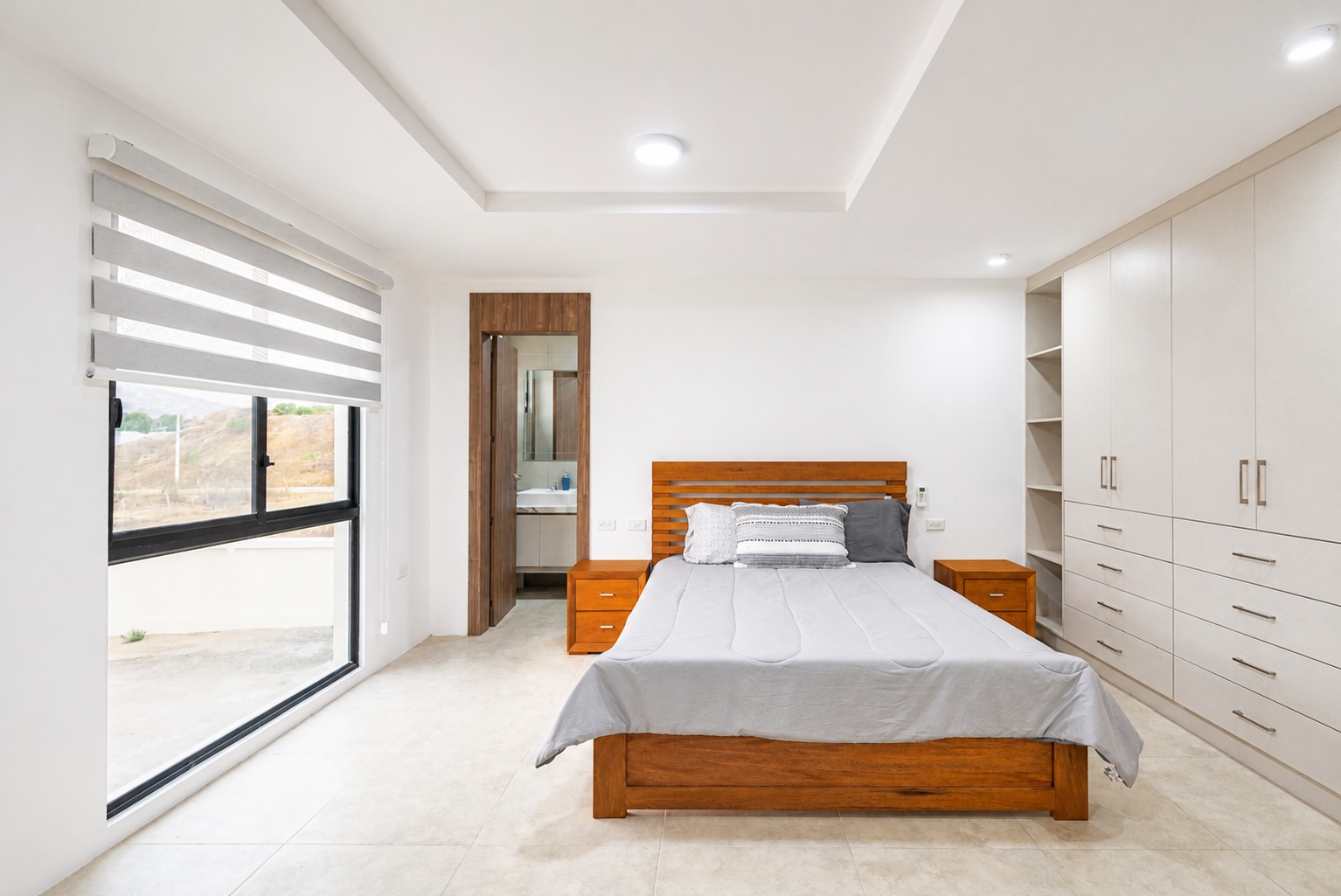 Bright guest bedroom with an ensuite bathroom and built-in storage