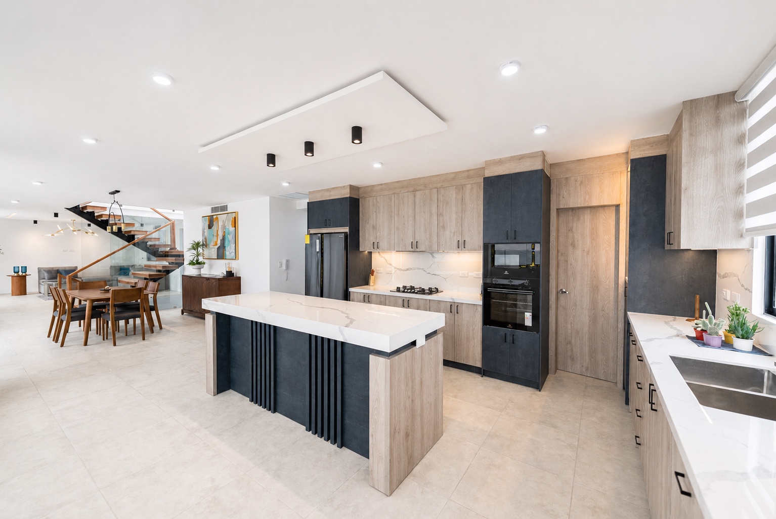Open-plan chef's kitchen with a large waterfall island and dining area