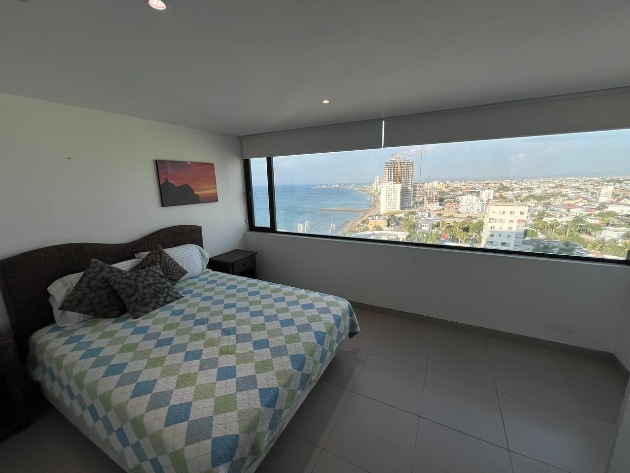 Primary bedroom with a wide panoramic ocean and city view