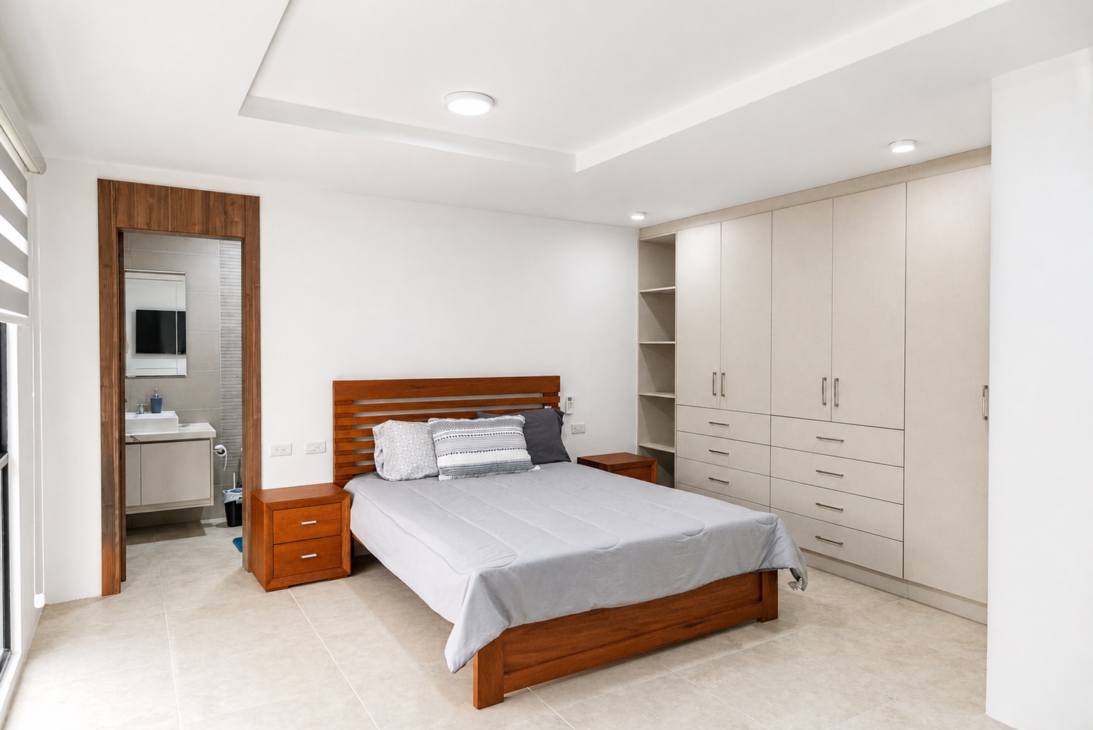 Guest bedroom with an ensuite bathroom and full-height wardrobes