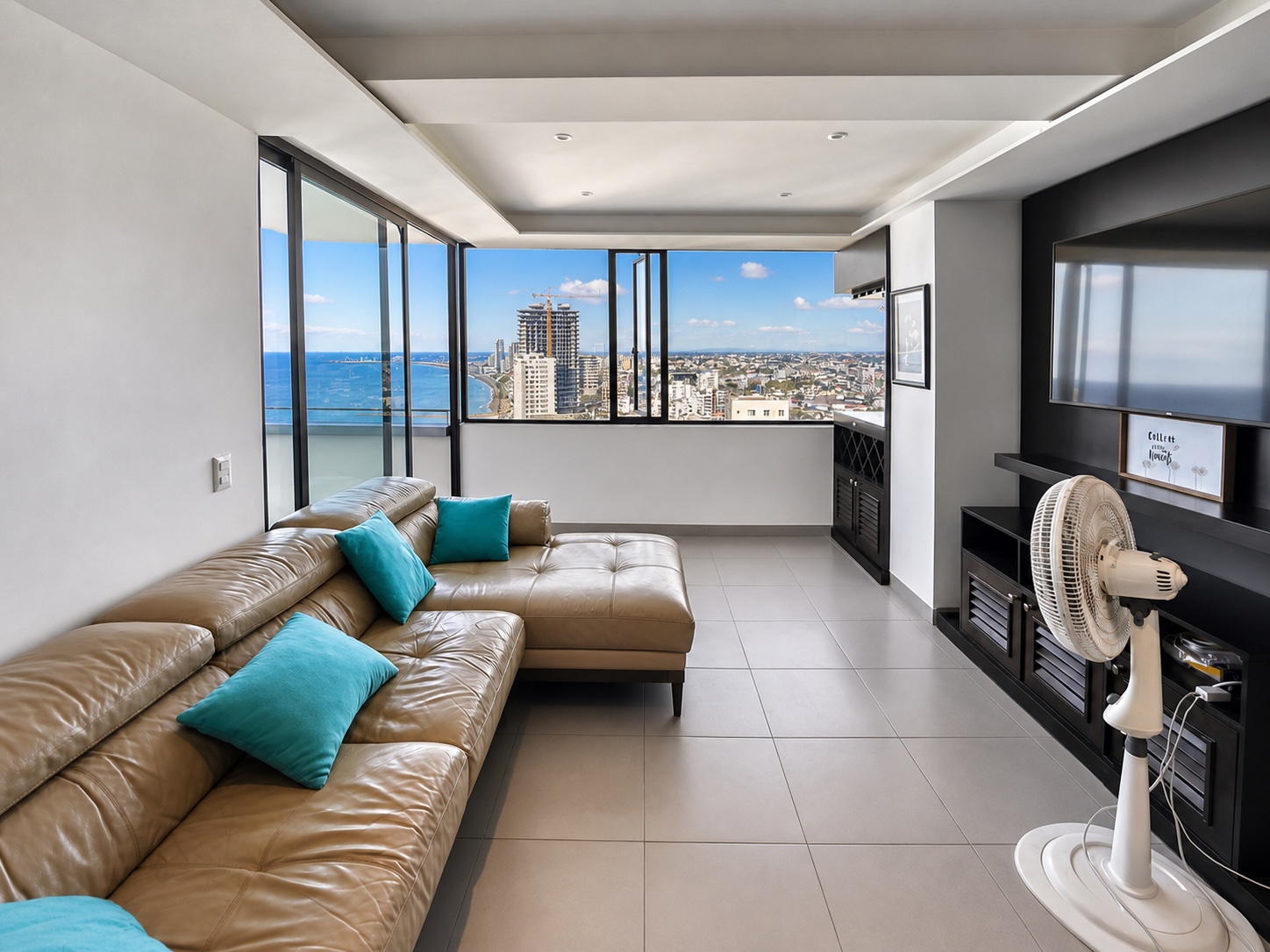 Wide living room with floor-to-ceiling windows and panoramic Manta coastline view