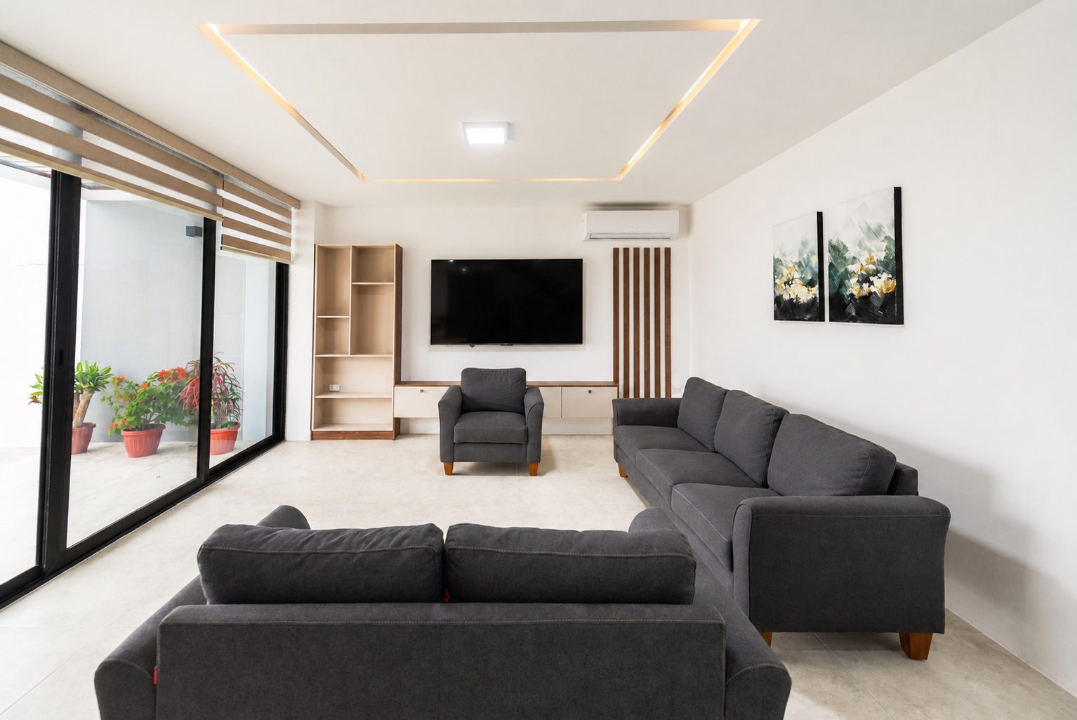 Modern living room with sectional seating and a wall-mounted television