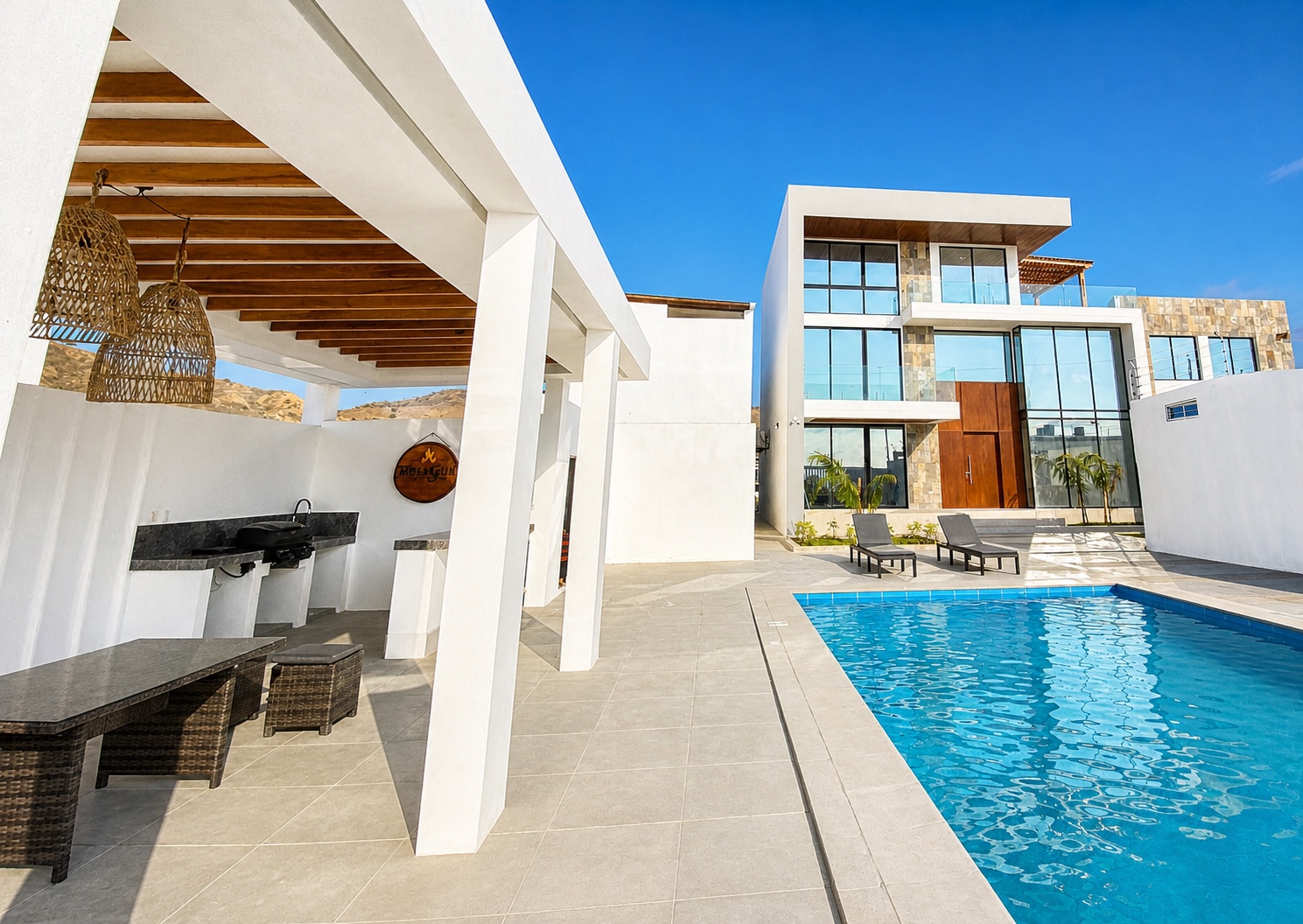 Private swimming pool, covered dining area, and modern villa exterior