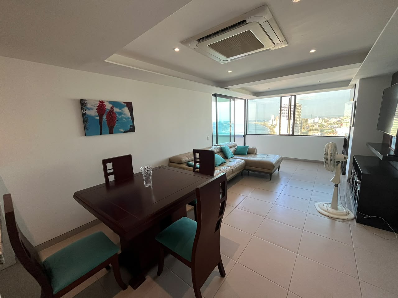 Open living and dining room with coastal views at Poseidon Manta Resort