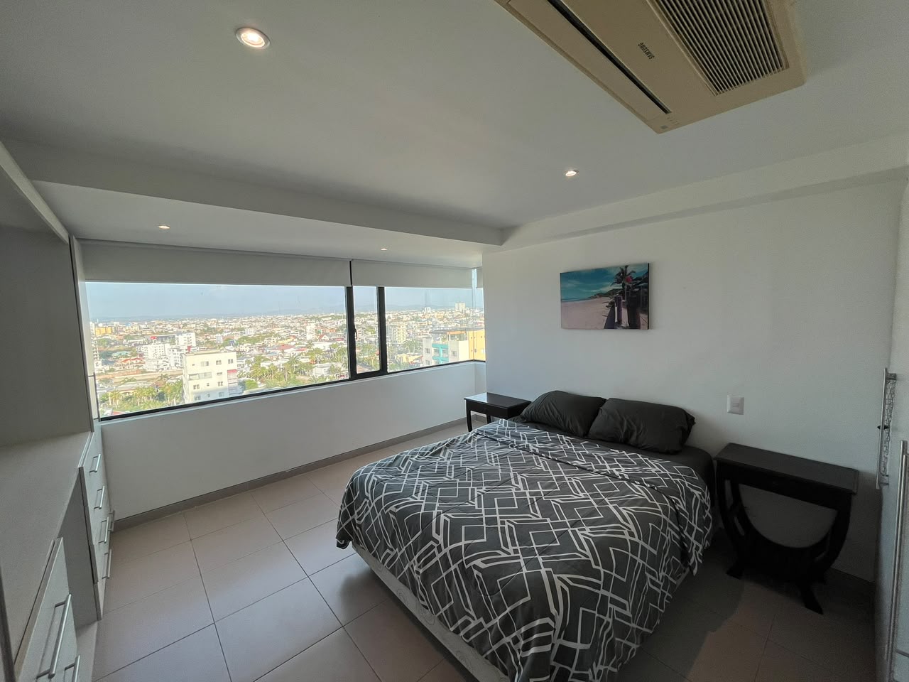 Second bedroom with city views and a queen bed