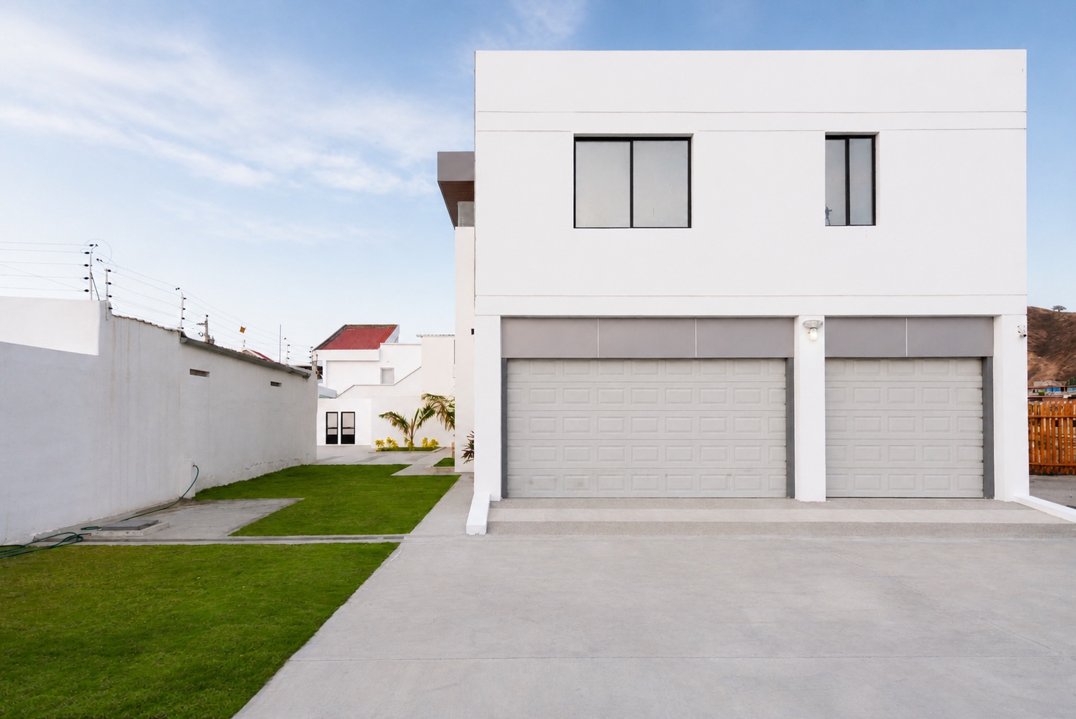 Private garage, driveway, and landscaped lawn at the Santa Marianita villa