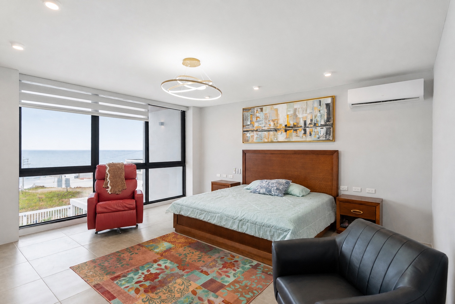 Primary bedroom with a panoramic ocean view at the Santa Marianita villa