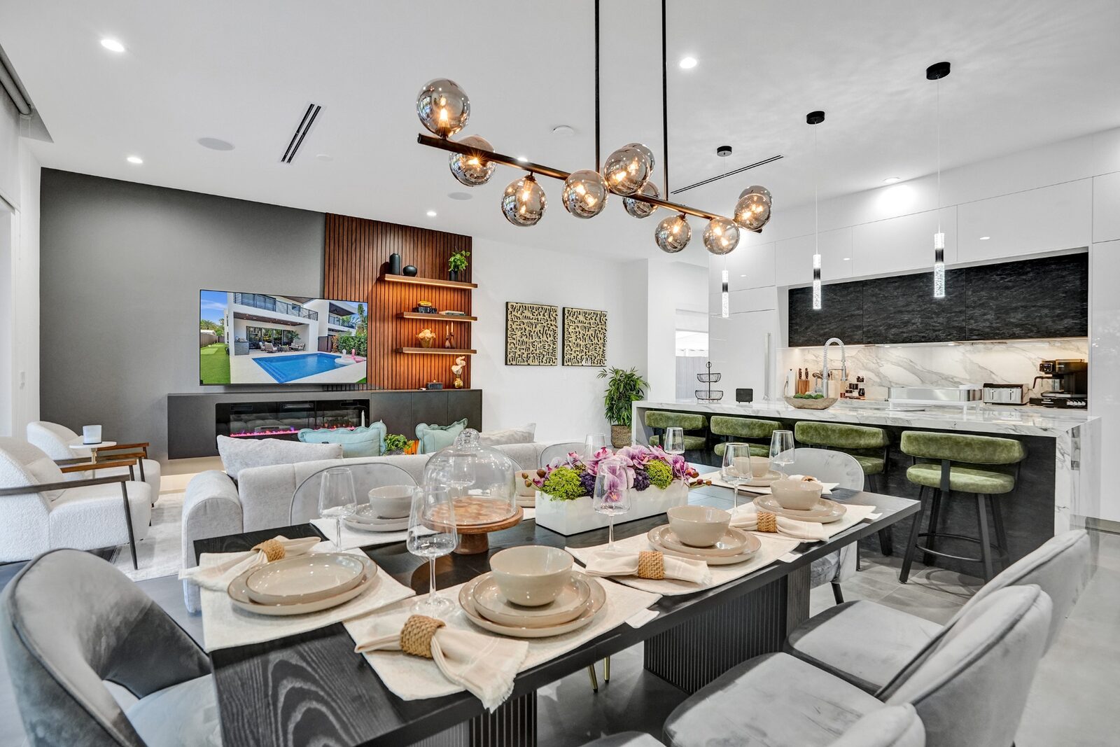 Elegant dining table set beside open-concept kitchen and living room
